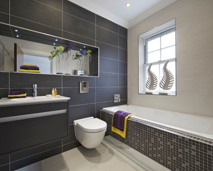 A modern bathroom fitted by Southampton Bathroom Fitters with black tile and yellow accents.