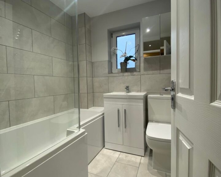 A Southampton bathroom design featuring a white toilet and sink.